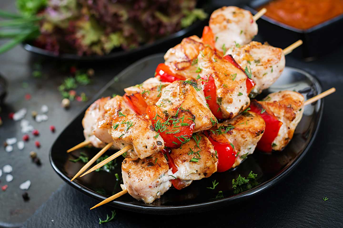 Chicken skewers with slices of sweet peppers and dill. Tasty foo